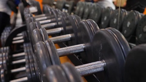 Dumbbells lying in a row in the gym. 4k. Slow motion Stock Footage 80073759