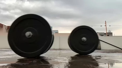 Dumbbells rolling on the brick floor. Stock Footage 128743960