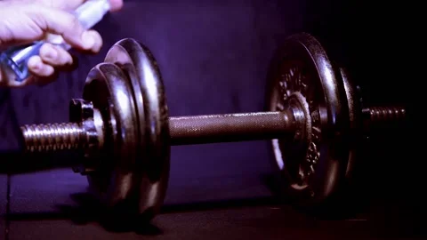 Dumbbells shot on a dark blue background sprayed and dissinfected 動画素材 150779781