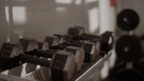 Dumbbells, weights on dumbbell rack in Muay Thai boxing gym 스톡 동영상 104547792