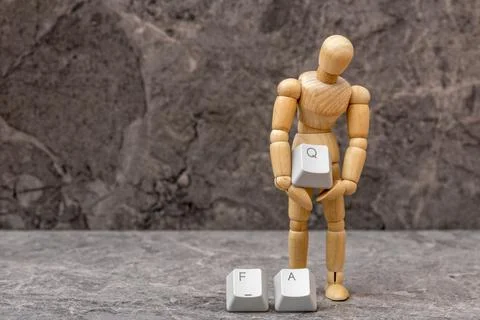 Dummy puts computer keyboard key with letter Q from the word FAQ 스톡 사진