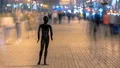 The dummy standing in a crowded street in the evening. time lapse 4k or 4k+ Resolution