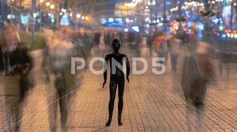 The dummy standing on the evening street with people Stock Photos
