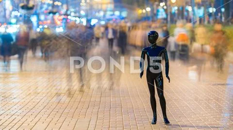 The dummy standing on the street among the stream of people Stock Photos