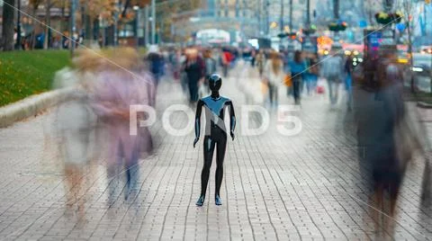The dummy standing on the street among the stream of people Stock Photos