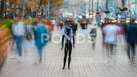 The dummy standing on the street among the stream of people Stock Photos