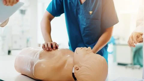 Dummy, student and cpr training in clinic for medical simulation exam, test or Stock Photos