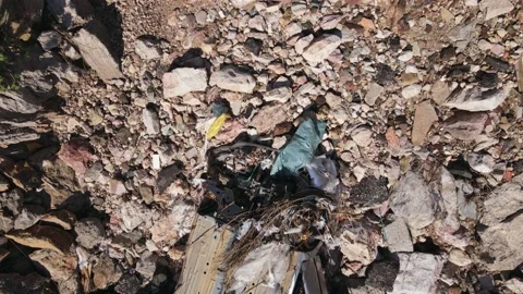 Dump with garbage and broken car on the rocks among cliffs on slope or on side Video stock 159126914