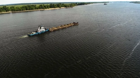 A dump scow transports sand down the river. Stock Footage 142073239