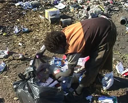 Dump site Kid looking in rubbish bags Stock Footage 11496772