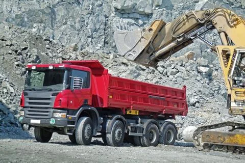Dump Truck and Excavator in a Quarry Stock Photos