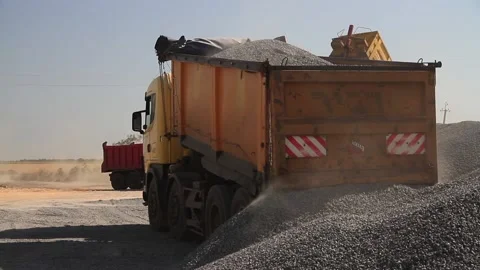 Dump truck at the construction site unloading stone and crushed stone. Big Truck 스톡 동영상 223354716