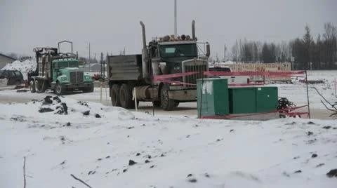 Dump Truck Driving through Winter Home Construction Zone Stock Footage 10754844
