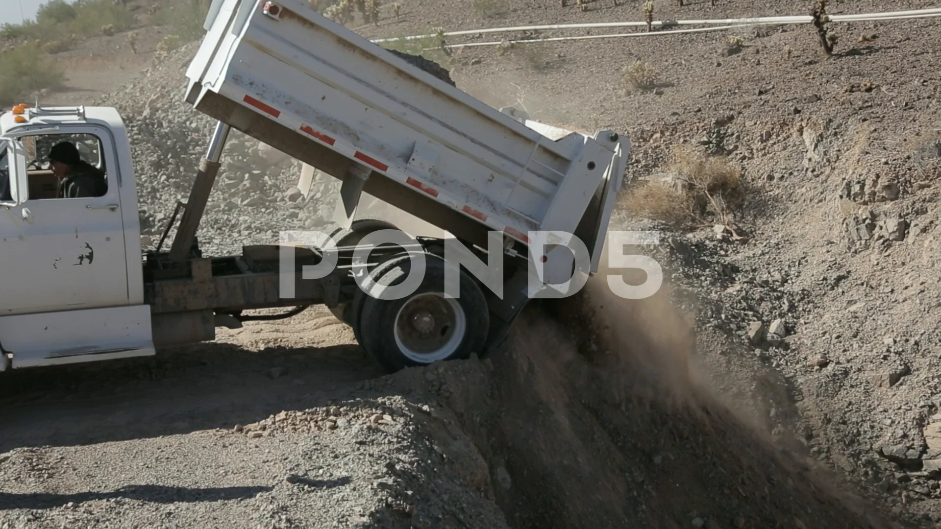 dump truck dumping dirt