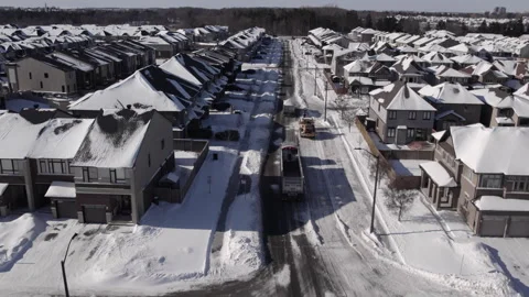 Dump truck full of snow pulls away as empty dump truck takes place for snow.. Stock Footage 328534595