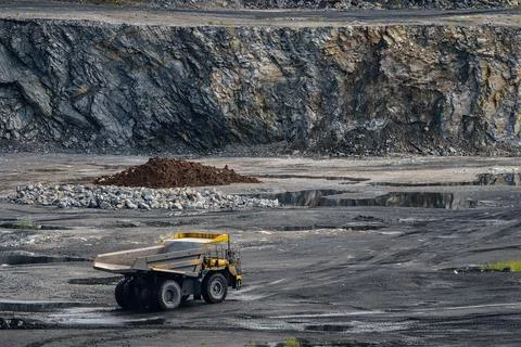 Dump truck in limestone mining, heavy machinery. Mining in the quarry. Photos