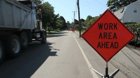 Dump truck passes work area sign on road Stock Footage 40712588