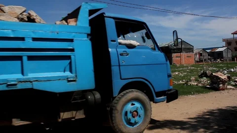Dump Truck Passing in Front of Garbage Field in Cambodia Stock Footage 100568219