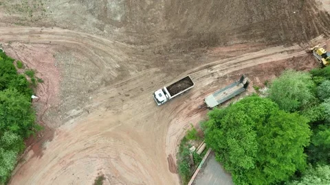 Dump truck reversing at construction site - Aerial drone view Stock Footage 341434032