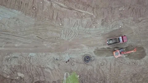 A dump truck transporting ground to the excavator Stock Footage 169323889