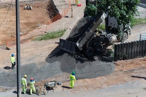 Dump truck unloading crushed stone at a construction site Stock Photos
