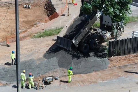 Dump truck unloading crushed stone at a construction site Photos