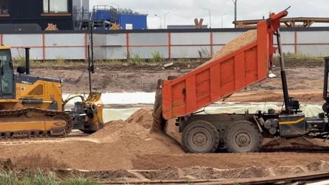Dump-truck-unloading-sand-bulldozer Stock Footage 342518329