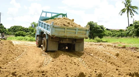 Dump truck unloading soil at construction site Stock Footage 64726319