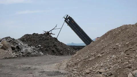 Dump truck unloading soil, ground sand from bucket. Russia, Stavropol, 10.06.20 Stock Footage 144243240