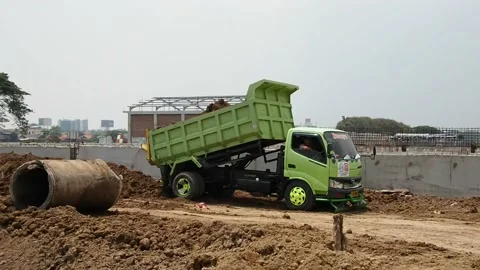 A dump truck is unloading some soil on project site. Stock Footage 159603656