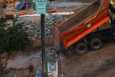 Dump truck unloading stones at a construction site Photos