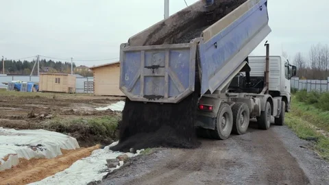 Dump Truck unloads the ground at the construction site. Video stock 73042170