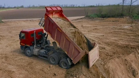 Dump Truck Unloads Sand in Construction Stock Footage 107269060
