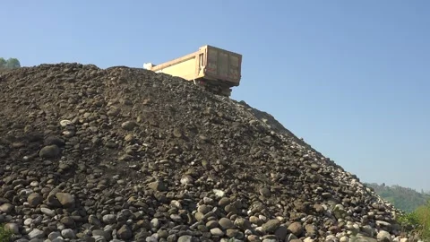 Dump truck unloads sand - Construction Machinery and Mechanical Unloading Stock Footage 339814227