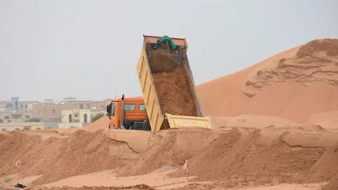 Dump Truck at work for new road construction through the sand Video stock 121604705