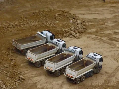 Dump trucks in construction site Stock Photos