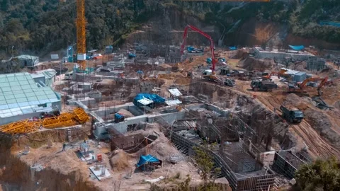 Dump trucks, cranes, excavators and workers roam around reinforcement cages Stock Footage 340629613