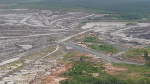 Dump trucks going back and forth transporting coal in a large mining area Stock Footage 332599589