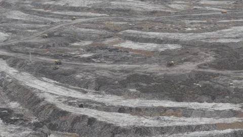 Dump trucks going back and forth transporting coal in a large mining area Stock Footage 332599680