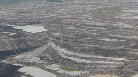 Dump trucks going back and forth transporting coal in a large mining area Stock Footage 332599750