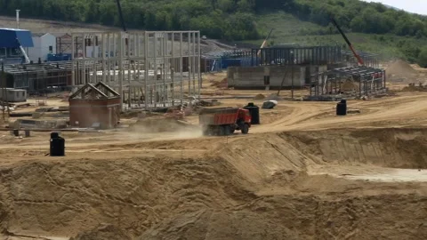 Dump trucks on industrial construction site with cranes 库存影片 331506684
