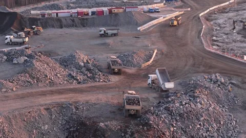 Dump trucks loading crushed stone in a quarry in Finland during spring Stock Footage 344427756