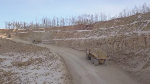 Dump trucks taking gold from the mining quarry drone view Stockbeeldmateriaal 136182899