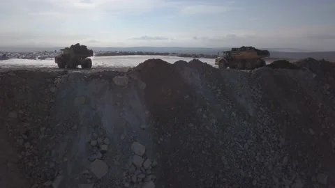 Dump trucks unload the gold. Drone view from quarry Video stock 136185084
