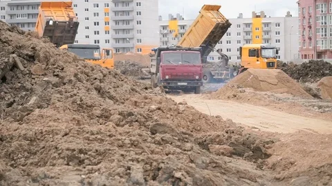 Dump trucks working on a construction site Stock Footage 78042821