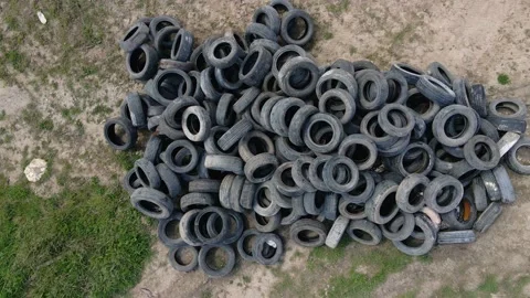 Dump of unwanted tires lying on the ground in an open field Video stock 153236407