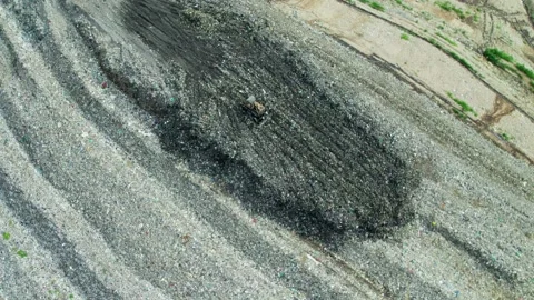 Dump Yard Ground Texture with Mixed Waste and Debris. day time, tilt down shot Stock Footage 324701483
