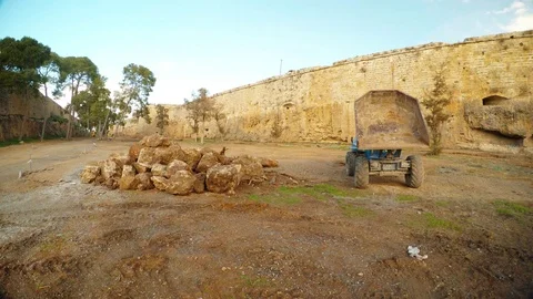 Dumper and a pile of stones on the bottom of a moat of a medieval fortress Stock Footage 82107963