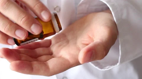 Dumping drugs, opening a vial of tablets, pills on hand Stock-Footage 68568196