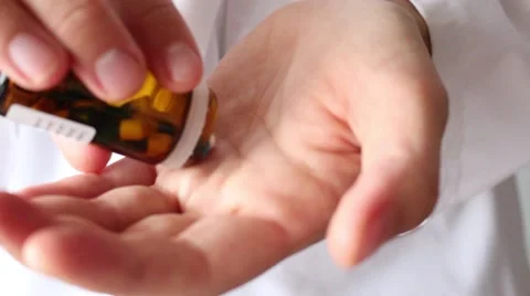 Dumping drugs, opening a vial of tablets, pills on hand Stock Footage 68568232